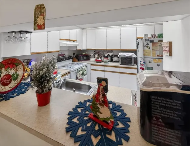 a kitchen with a refrigerator and cabinets