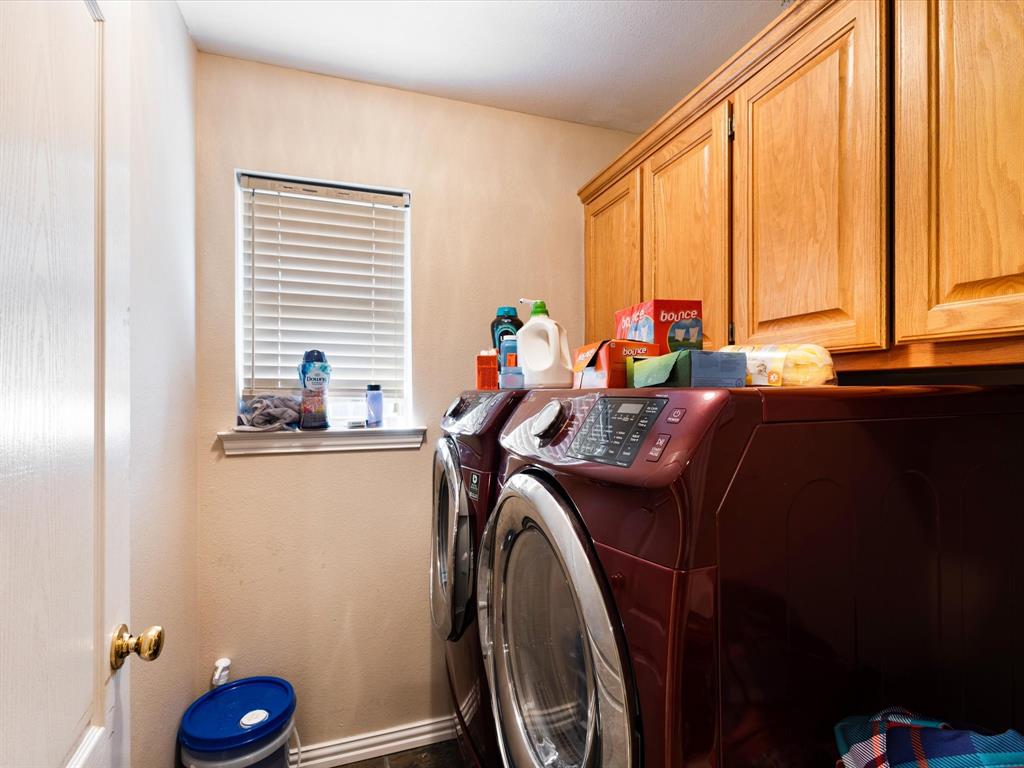 207 Quail Run Aubrey, TX 76227 - Photo 11 of 30 Laundry room featuring washer and clothes dryer and cabinet space