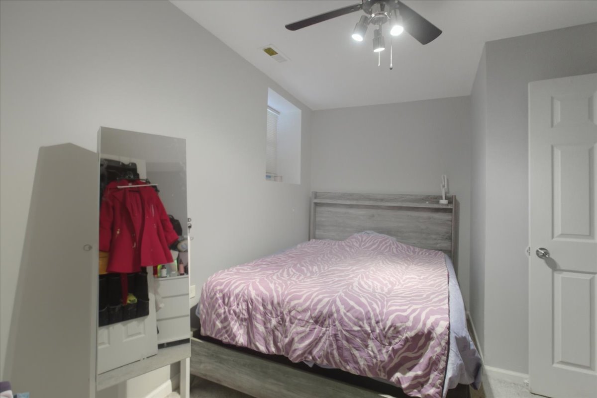 4423 South Prairie Avenue, Unit GARDEN Chicago, IL 60653 - Photo 9 of 13 a bedroom with a bed and a walk in closet