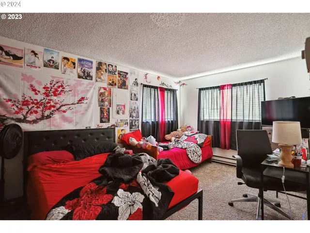 a bedroom with a bed and a mirror