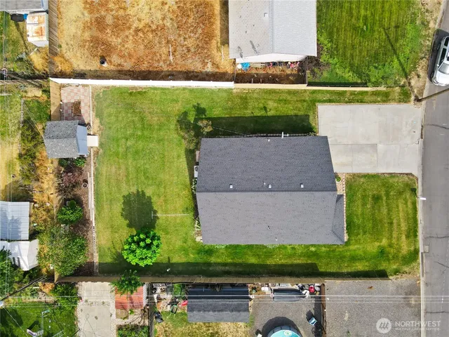 an aerial view of a house with a yard and lake view