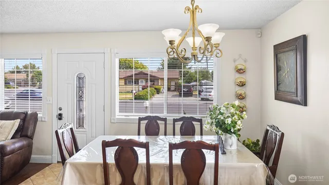 a view of a dining room with furniture wooden floor and chandelier