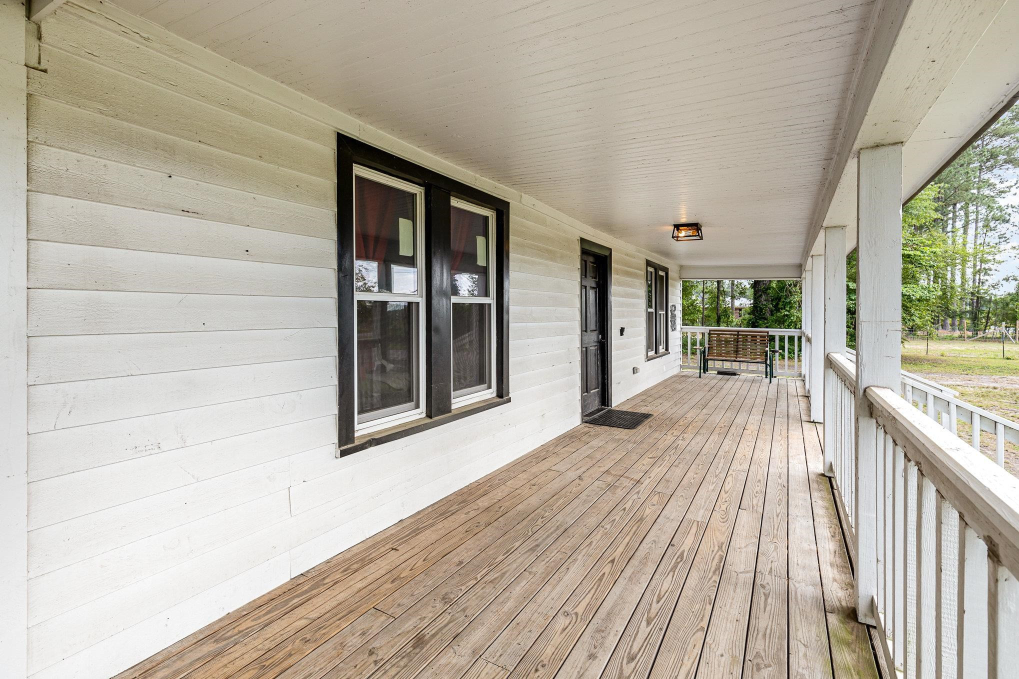 3716 Hayfield Road Wade, NC 28395 - Photo 3 of 24 The porch runs the length of the front of the home, and wraps around one side. Covered Porch