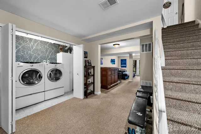 a view of a storage and utility room with washer and dryer