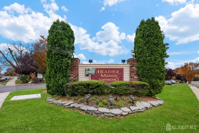 a view of a house with a big yard plants and large trees