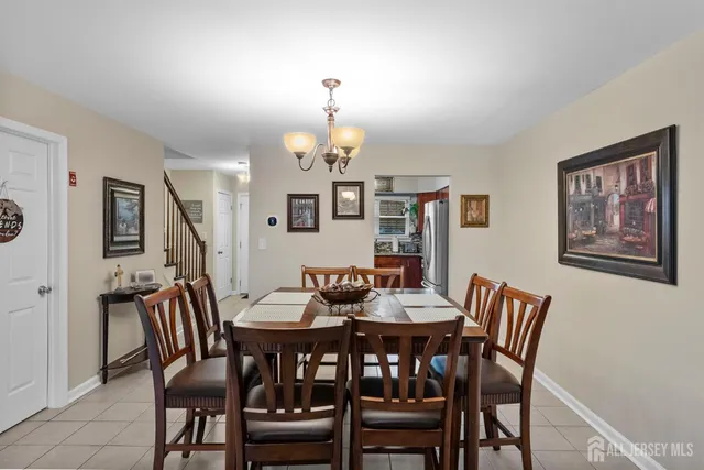 a view of a dining room with furniture a chandelier and wooden floor