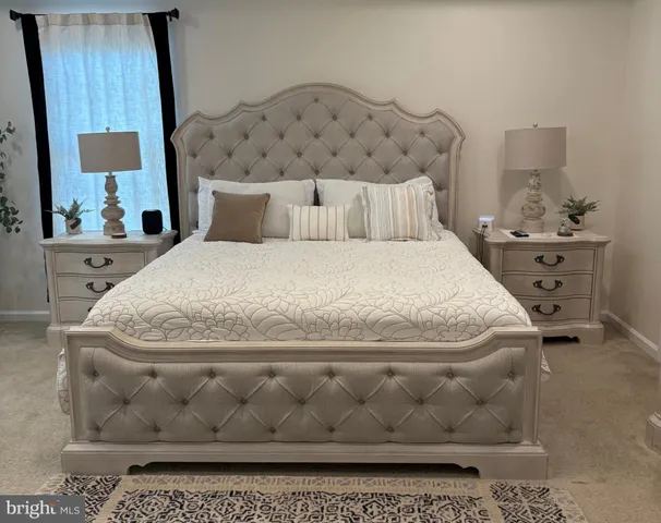 a large white bed in a small room