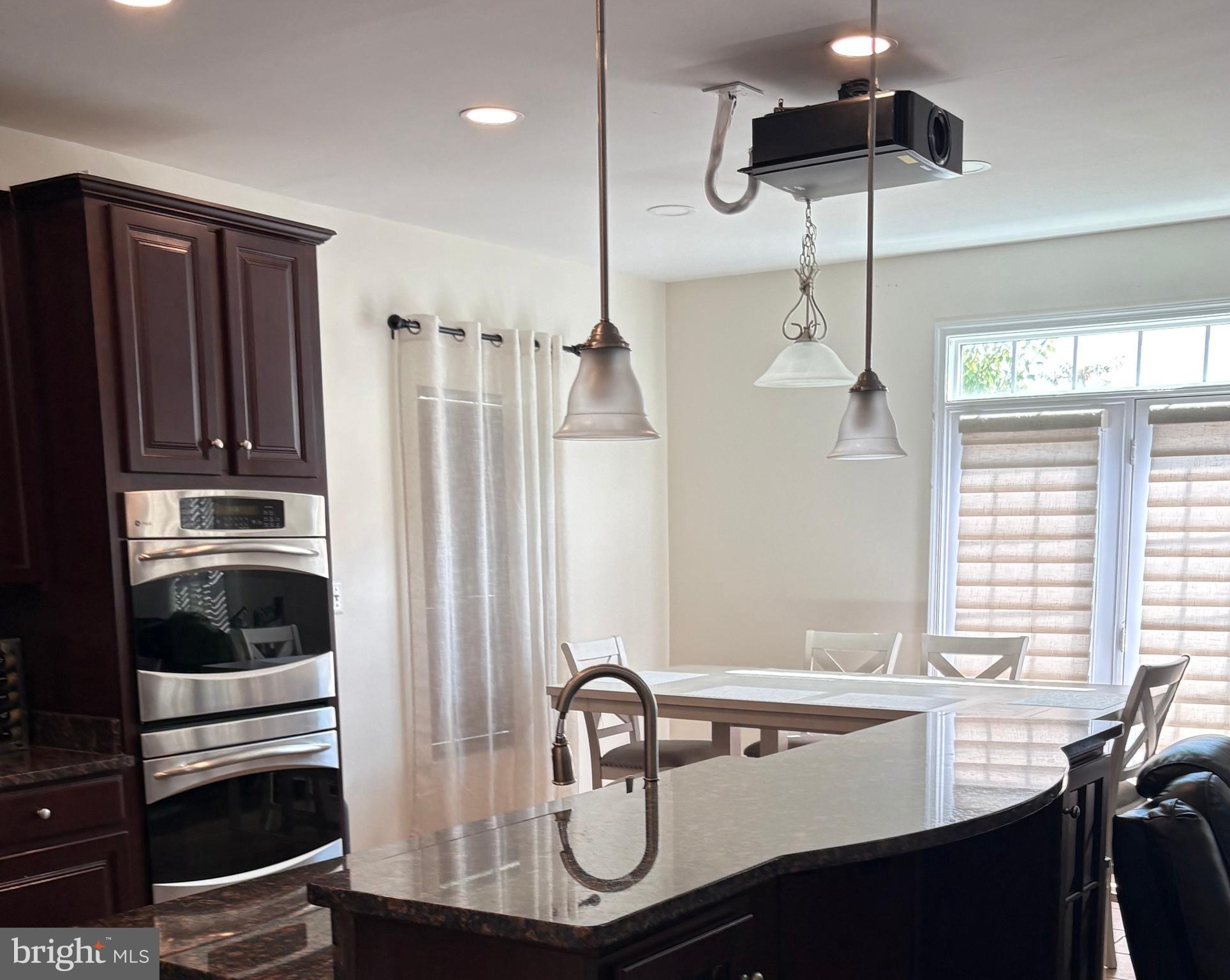 15145 Leicestershire Street Woodbridge, VA 22191 - Photo 4 of 19 a kitchen with a sink a stove and refrigerator