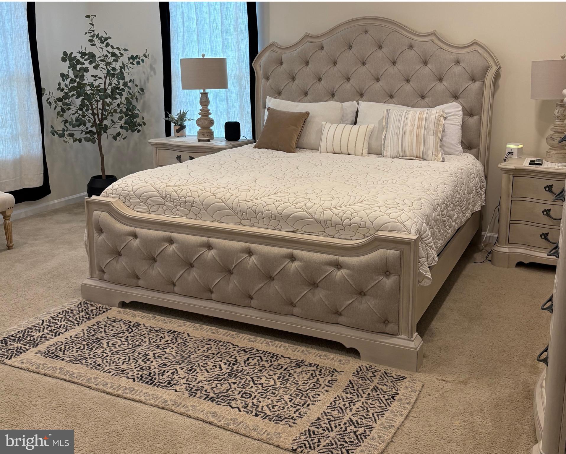 15145 Leicestershire Street Woodbridge, VA 22191 - Photo 5 of 19 a large bed sitting in a bedroom next to a lamp