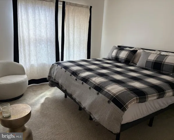 a bedroom with a bed and window