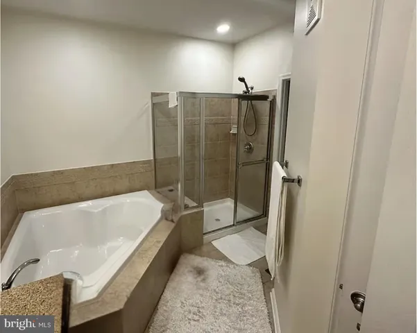 a bathroom with a tub and a shower