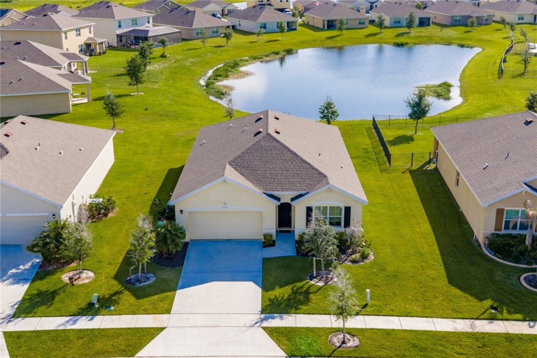 3453 Trinity Circle Fort Pierce, FL 34945 - Photo 24 of 36 an aerial view of a house with a swimming pool