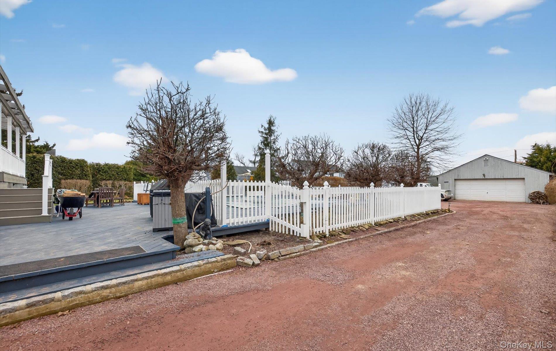 108 Awixa Avenue Bay Shore, NY 11706 - Photo 39 of 47 Fenced front yard with a deck, a garage, and an outbuilding