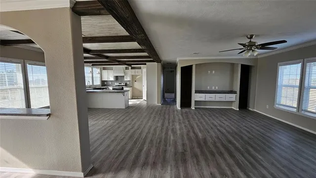 wooden floor in an empty room with a kitchen