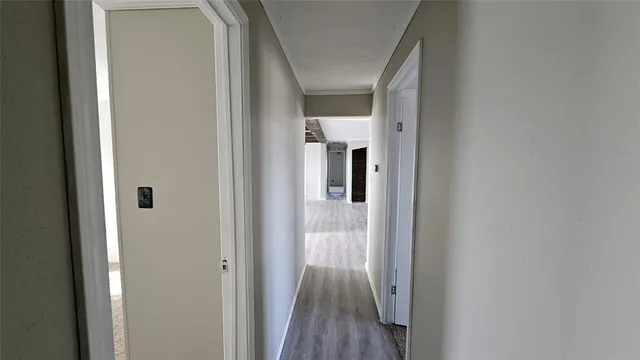 a view of a hallway with wooden floor