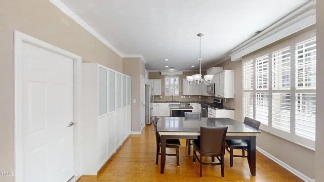 a dining room with furniture window and wooden floor