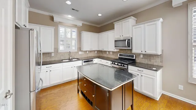 a kitchen with a sink stove top oven and refrigerator