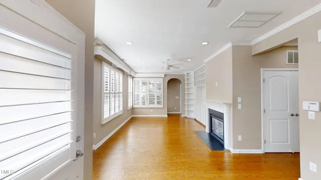 a view of an empty room with a fireplace and a window