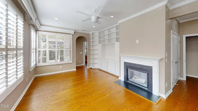 a view of an empty room with a fireplace and a window