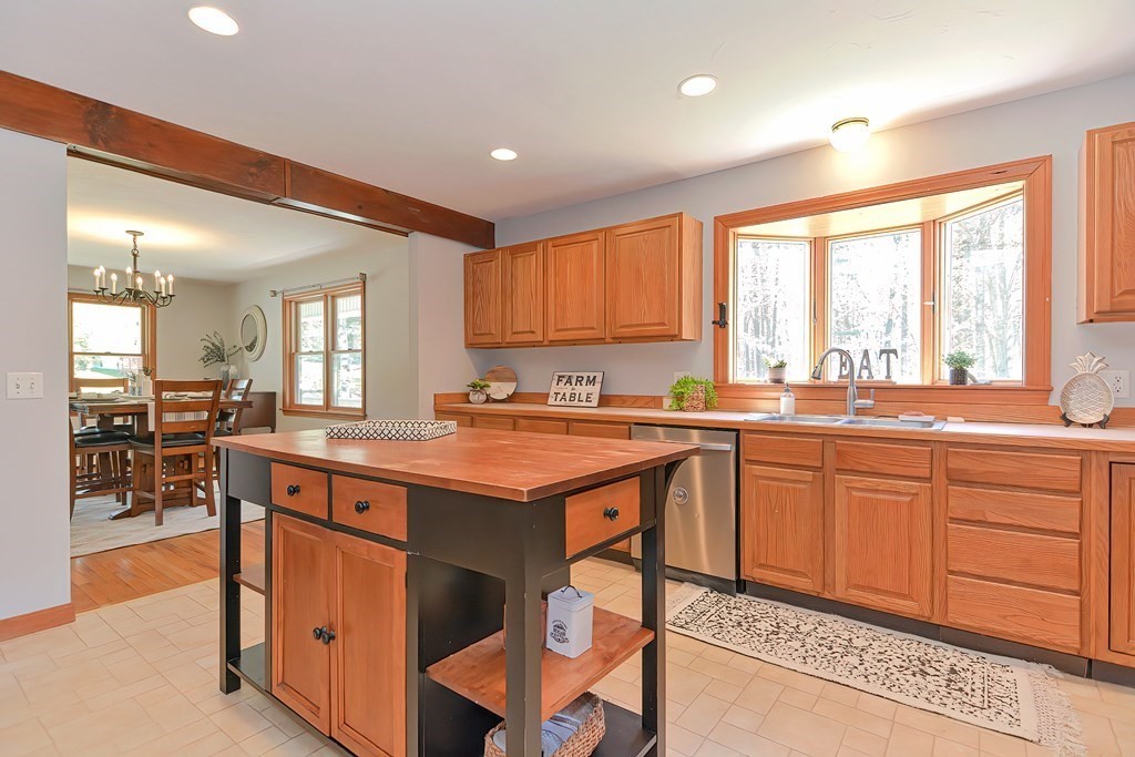 71 Lancaster Road Shirley, MA 01464 - Photo 16 of 34 a open kitchen with stainless steel appliances granite countertop a stove a sink dishwasher and a refrigerator with wooden cabinets