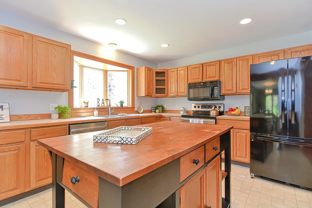 71 Lancaster Road Shirley, MA 01464 - Photo 17 of 34 a kitchen with stainless steel appliances granite countertop a sink stove and refrigerator