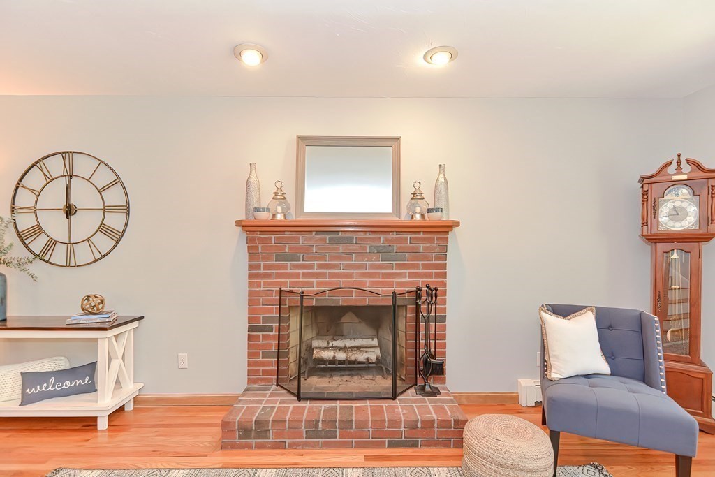 71 Lancaster Road Shirley, MA 01464 - Photo 8 of 34 a living room with furniture a mirror and a fireplace