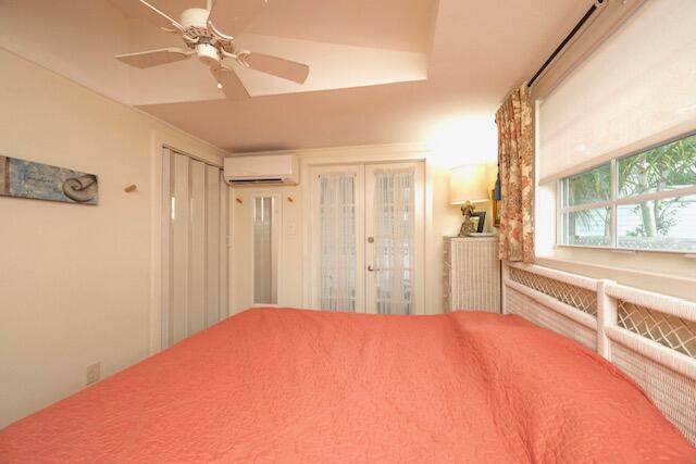 1218 Packer Street, Unit REAR Key West, FL 33040 - Photo 10 of 22 a bedroom with a large bed and a chandelier