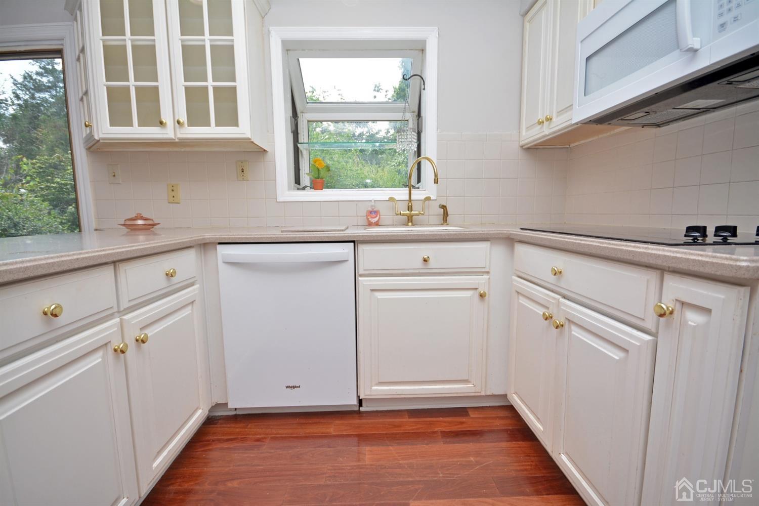 44 Johnson Road Somerset, NJ 08873 - Photo 4 of 27 a view of cabinets a window and a sink