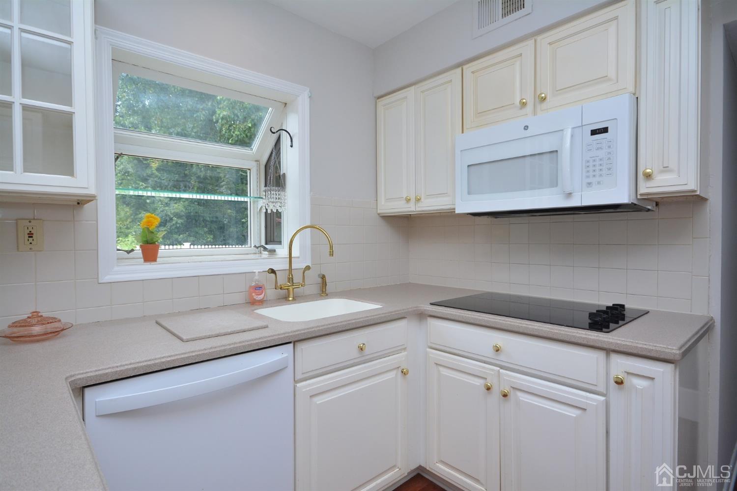 44 Johnson Road Somerset, NJ 08873 - Photo 5 of 27 a kitchen with white cabinets and a sink