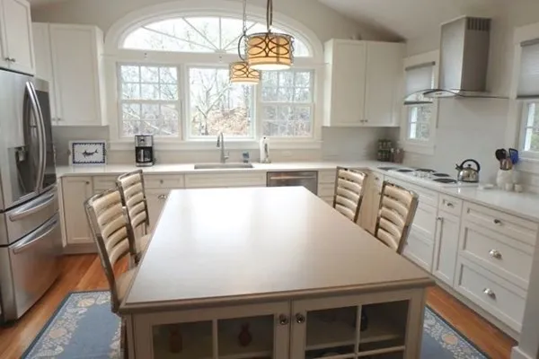 a kitchen with stainless steel appliances a stove a sink a microwave and cabinets
