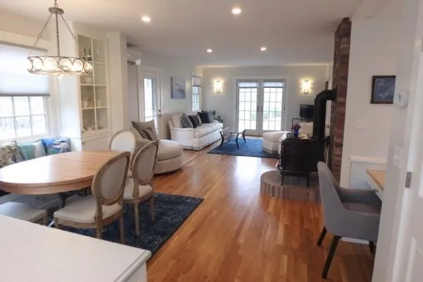 a living room with furniture and a chandelier