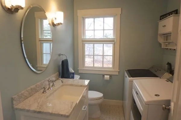 a bathroom with a sink a toilet and a mirror
