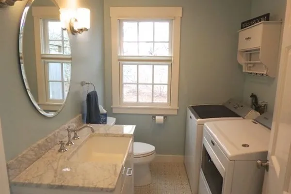 a bathroom with a sink a toilet and a mirror