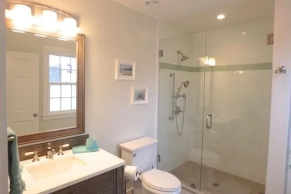 a bathroom with a sink a toilet and shower