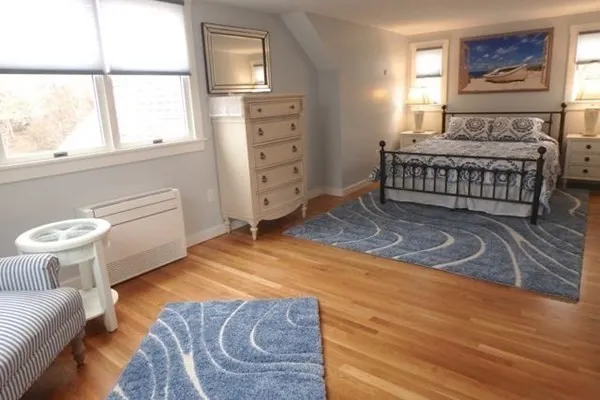 a spacious bedroom with a bed and a window