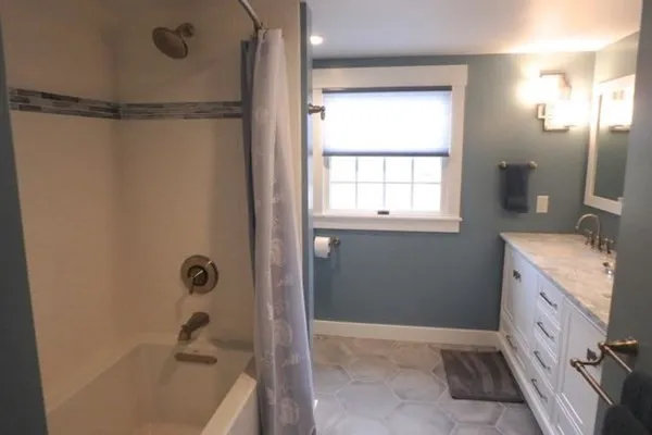 a bathroom with a tub sink and shower