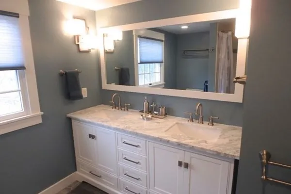 a bathroom with a granite countertop sink and a mirror