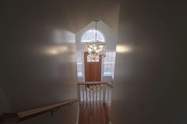 a view of a hallway with chandelier