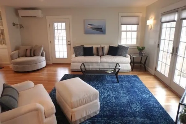 a living room with furniture and a rug