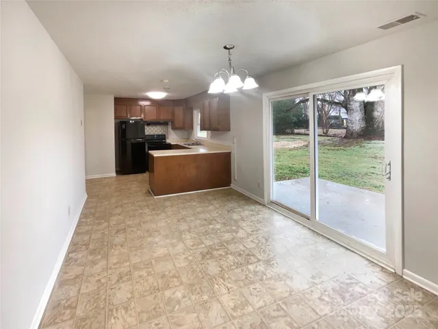 a view of a room and kitchen view
