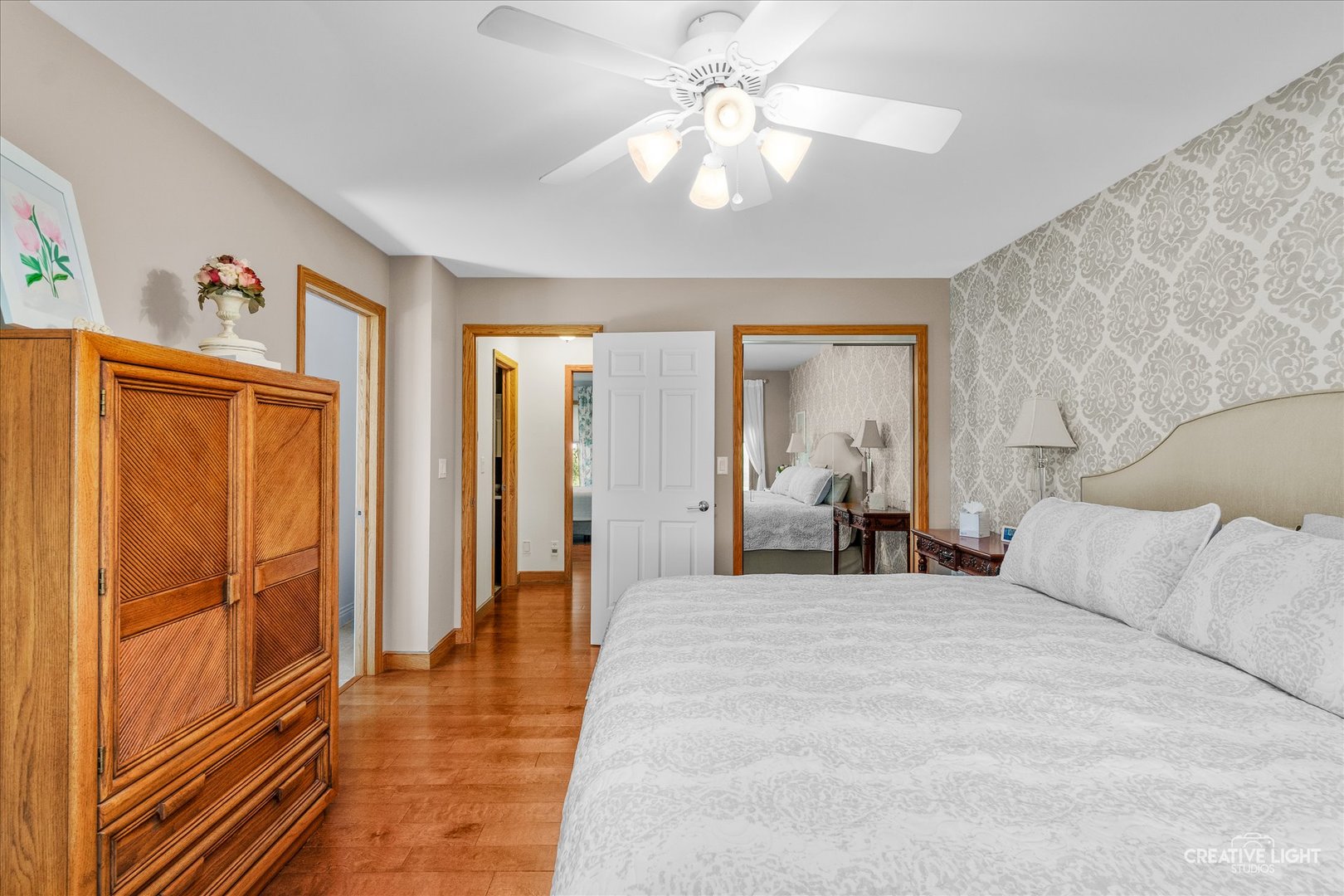 14050 Townhouse Road Newark, IL 60541 - Photo 15 of 45 a large bedroom with a large bed and a chandelier