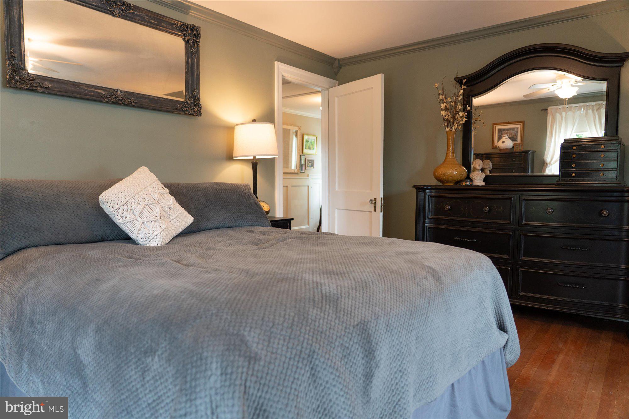 10 North Concord Road West Chester, PA 19382 - Photo 32 of 60 a bedroom with a bed and a mirror on dresser