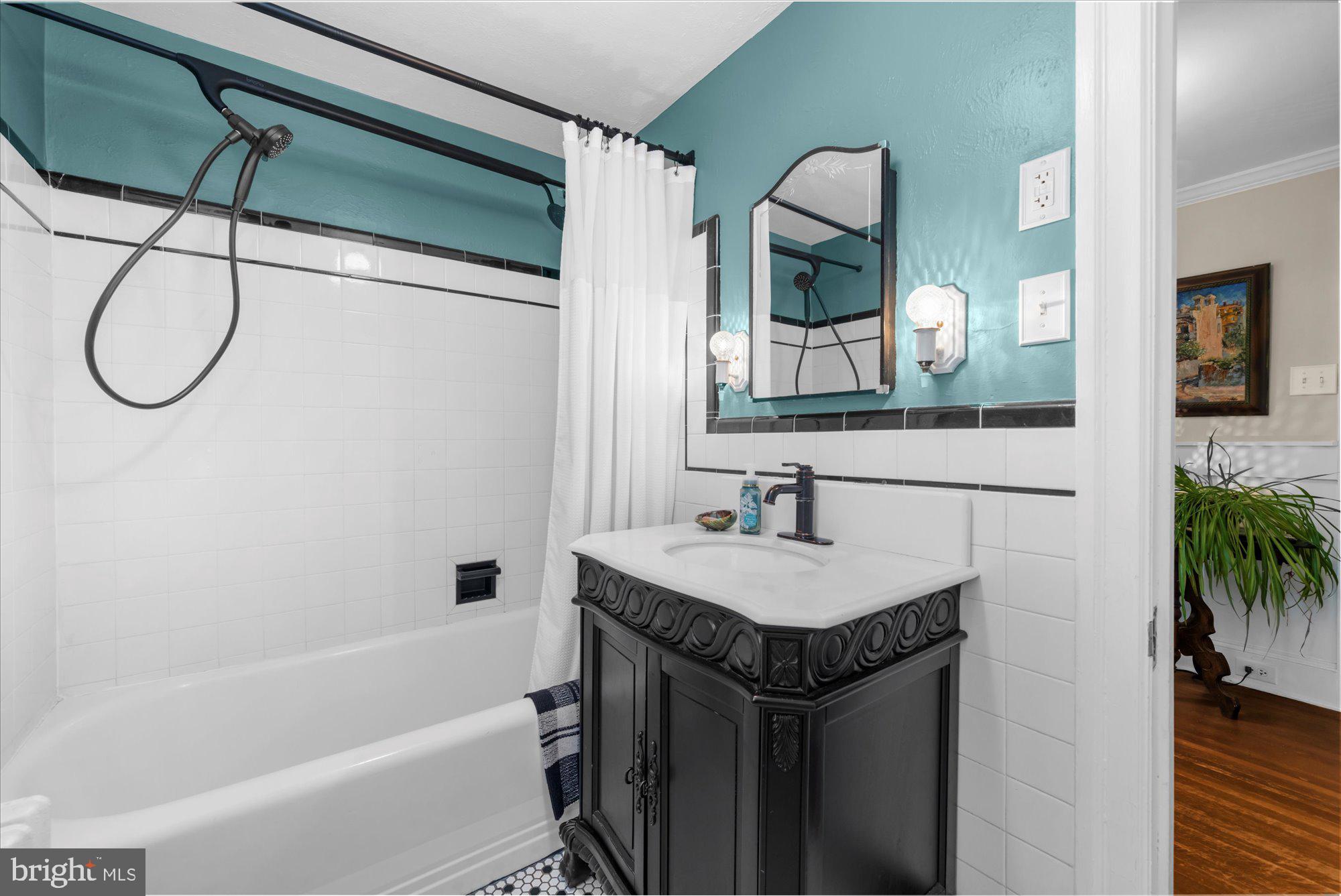 10 North Concord Road West Chester, PA 19382 - Photo 34 of 60 a bathroom with a granite countertop sink a mirror a vanity and a bathtub