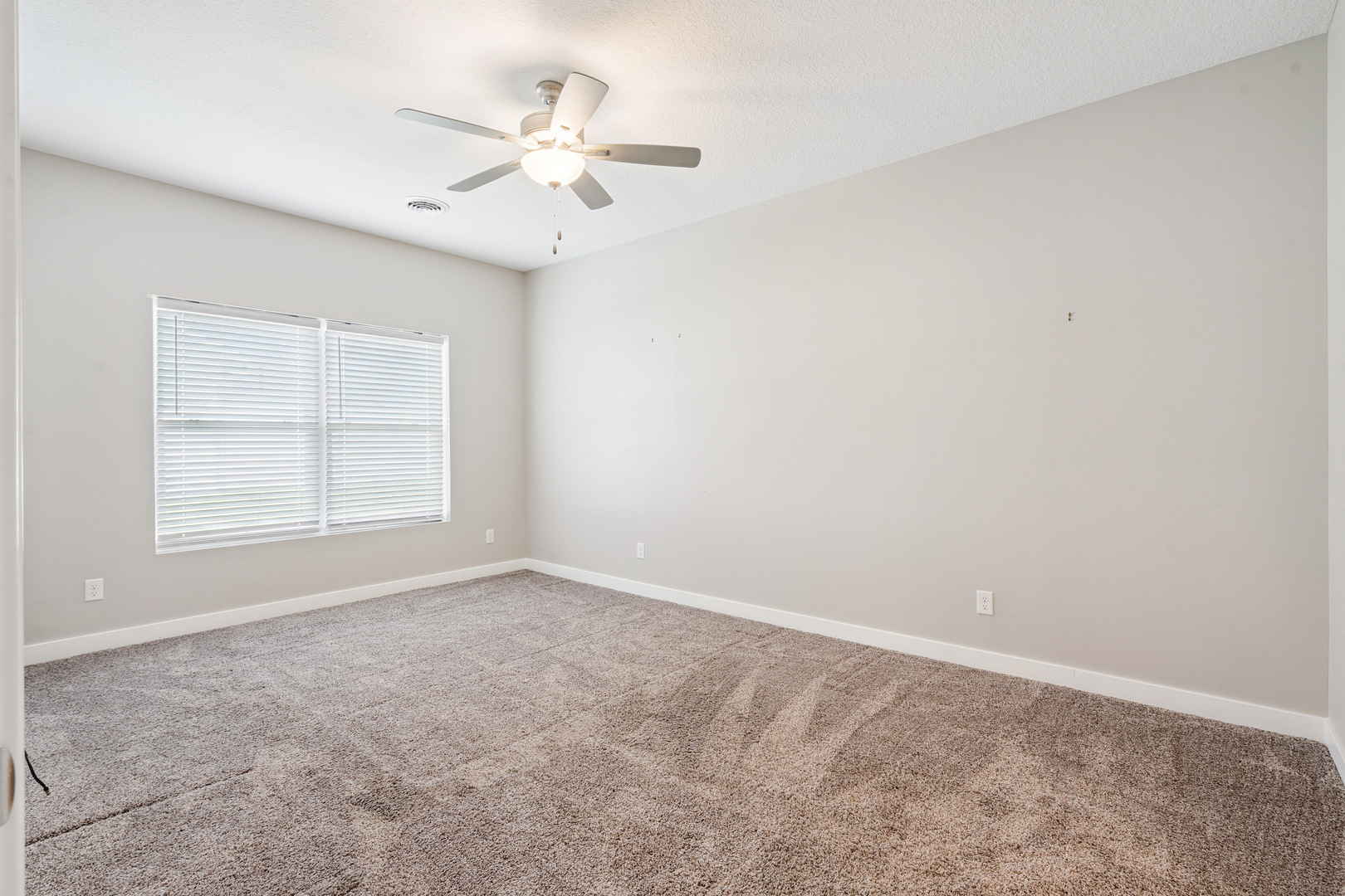 2406 13th Street Silvis, IL 61282 - Photo 12 of 22 an empty room with windows and fan