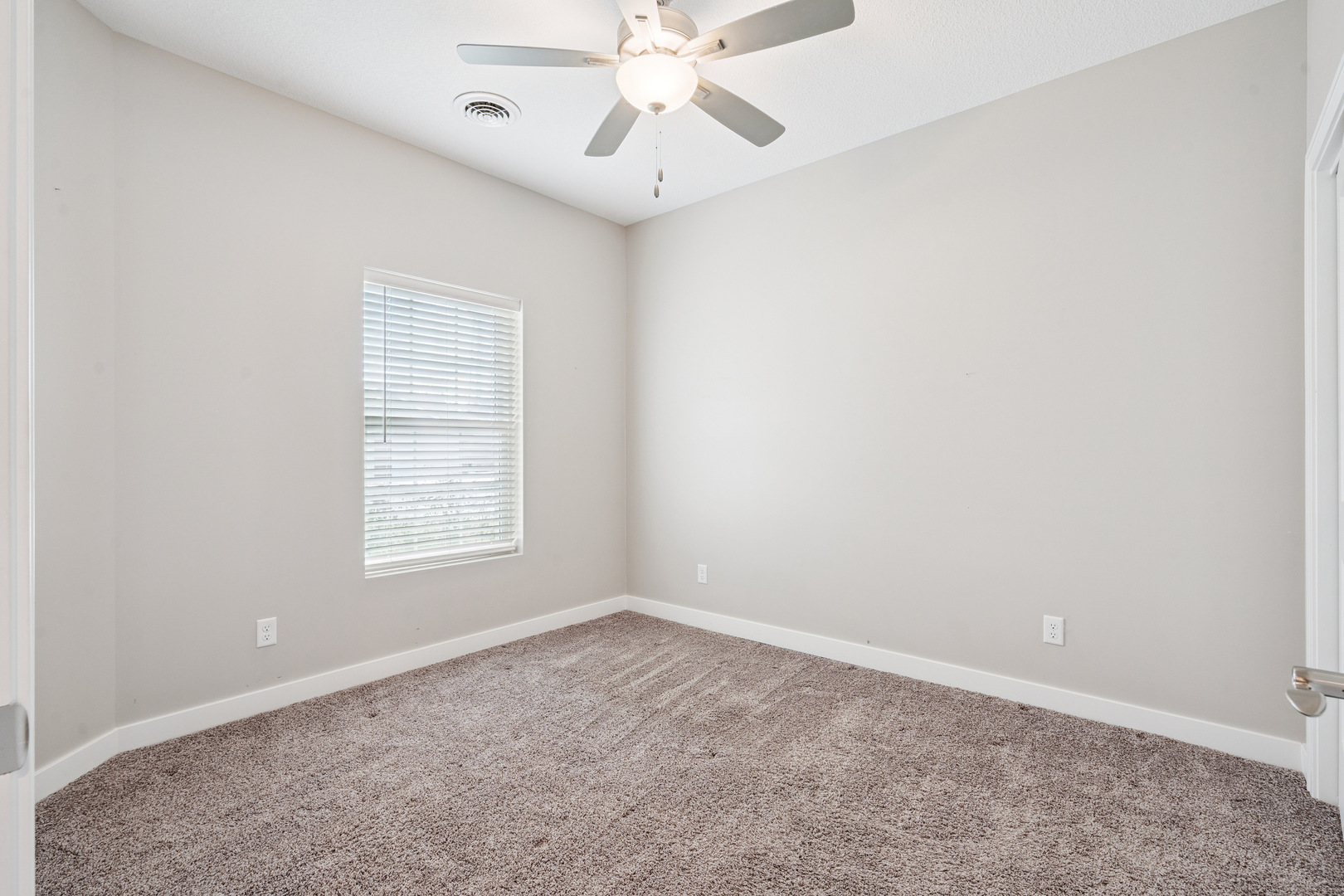 2406 13th Street Silvis, IL 61282 - Photo 14 of 22 an empty room with a window and a fan