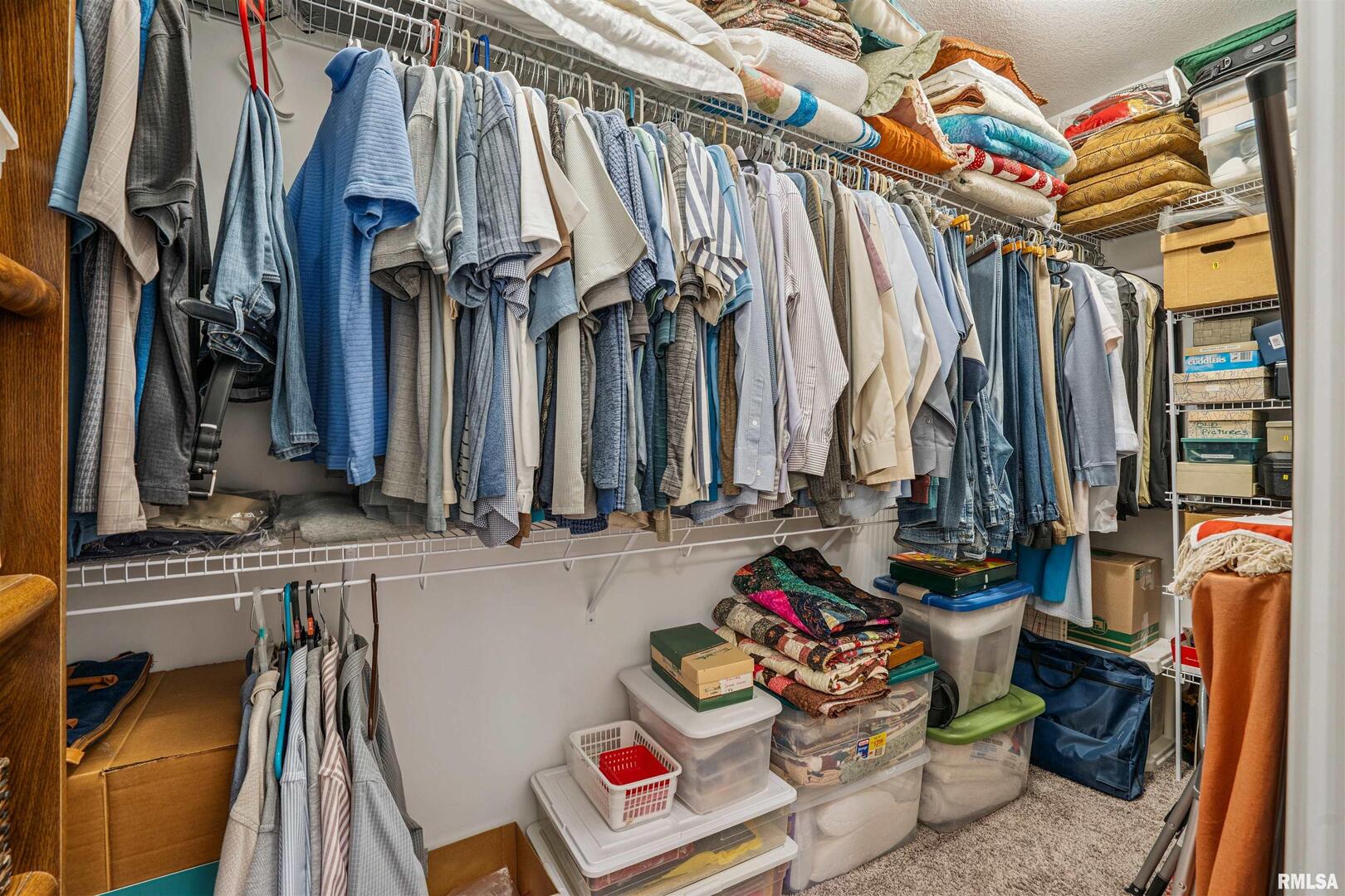 2406 13th Street Silvis, IL 61282 - Photo 16 of 22 a view of walk in closet with clothes and shoes