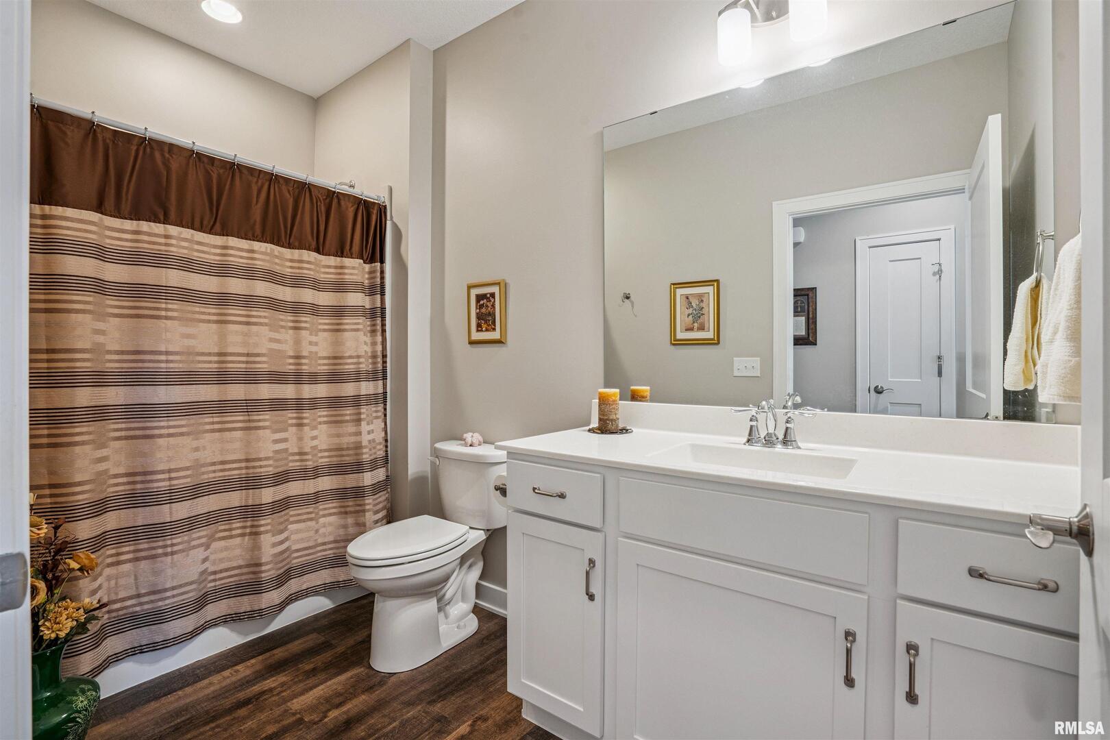 2406 13th Street Silvis, IL 61282 - Photo 17 of 22 a bathroom with a sink a toilet and shower