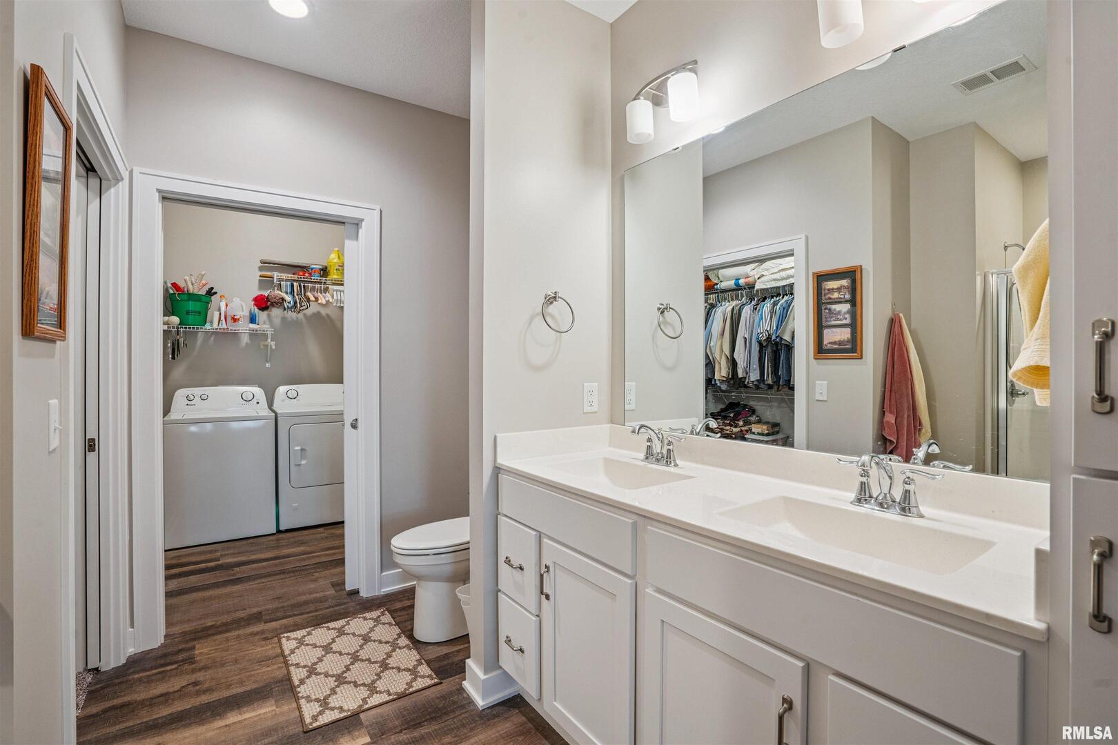 2406 13th Street Silvis, IL 61282 - Photo 18 of 22 a bathroom with a sink a toilet and shower a mirror