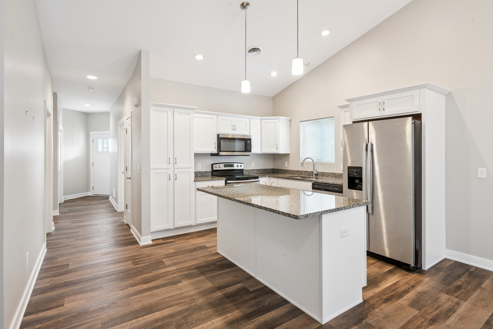 2406 13th Street Silvis, IL 61282 - Photo 4 of 22 a kitchen with stainless steel appliances granite countertop a refrigerator a sink dishwasher a stove and white cabinets with wooden floor