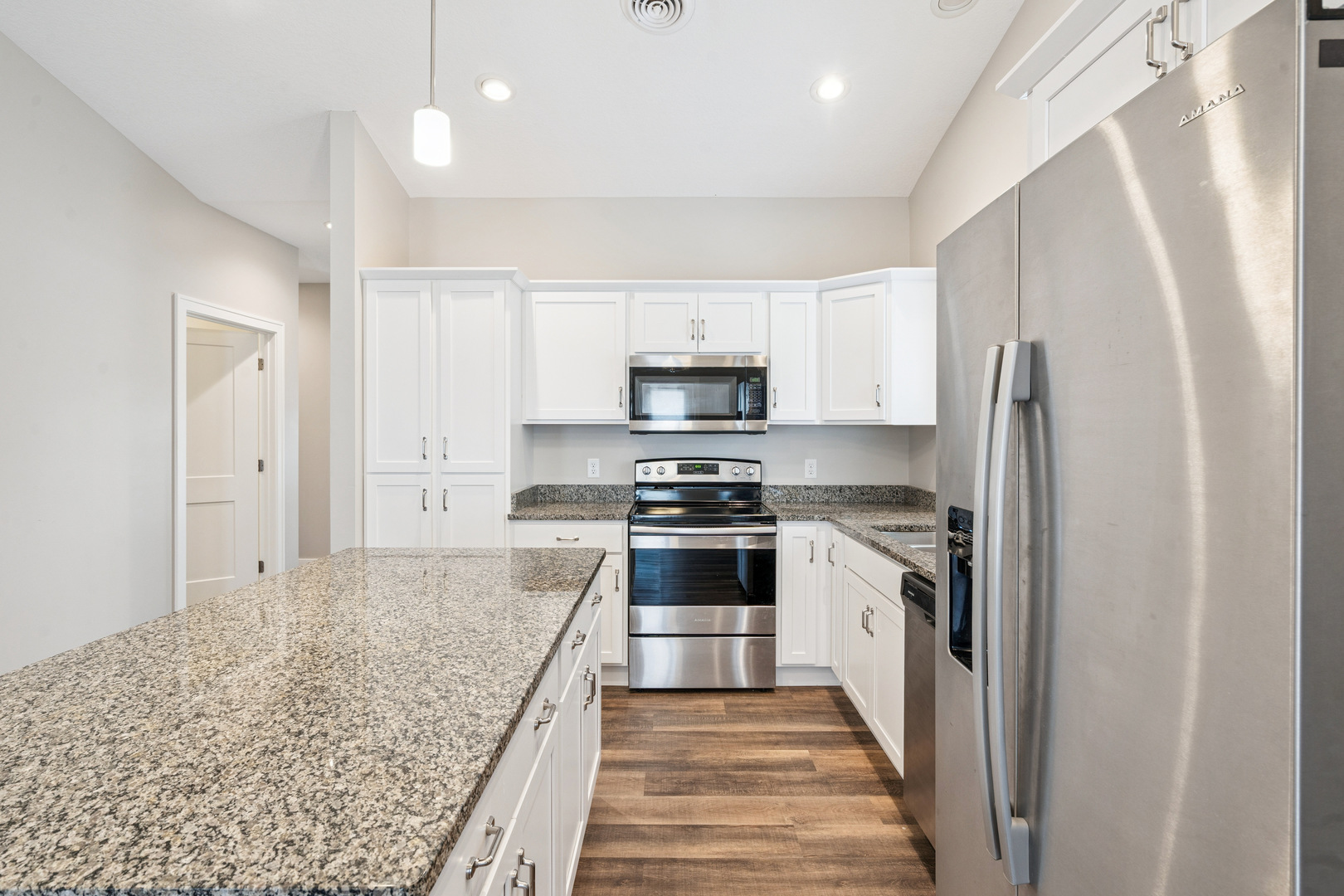 2406 13th Street Silvis, IL 61282 - Photo 6 of 22 a kitchen with granite countertop a refrigerator and a sink